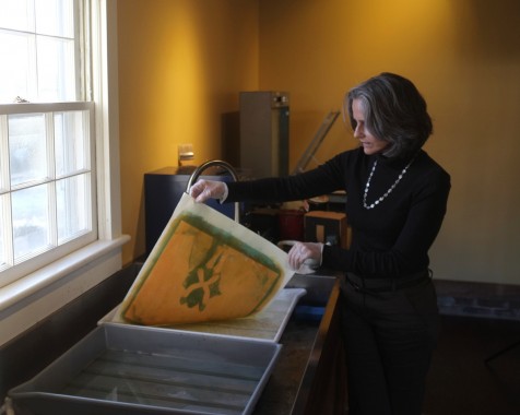 Diana Bloomfield rinsing a gum print in her Raleigh studio. Photo by ©Tim Lytvinenko, 2014
